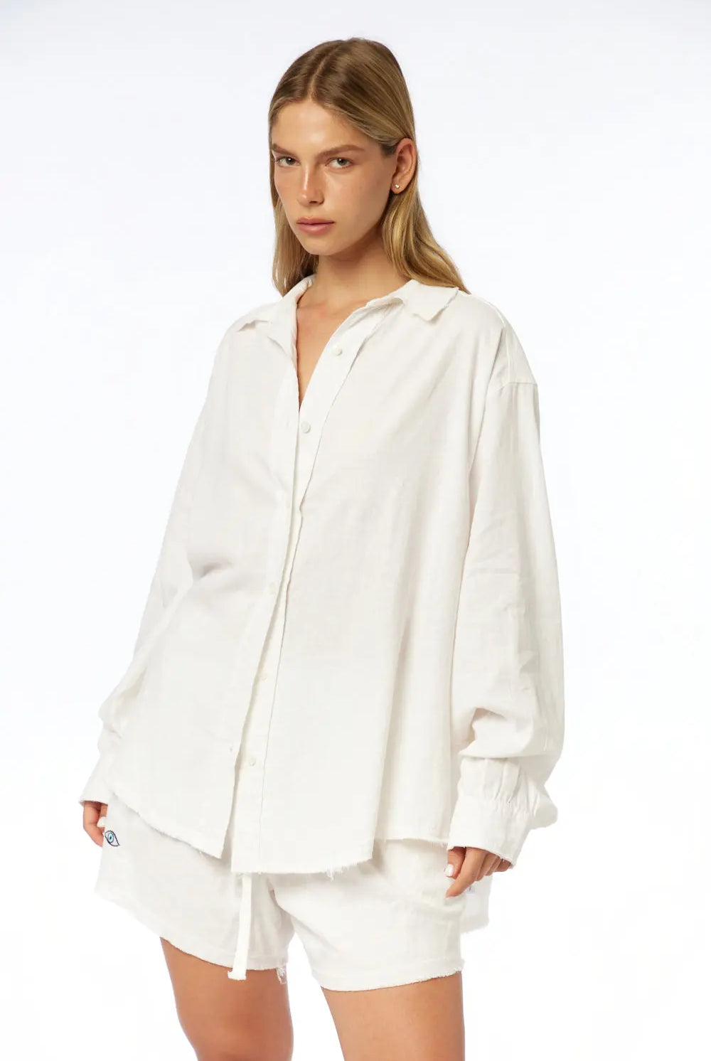 Woman wearing white Pure Linen Women's Shorts and a matching oversized white linen shirt
