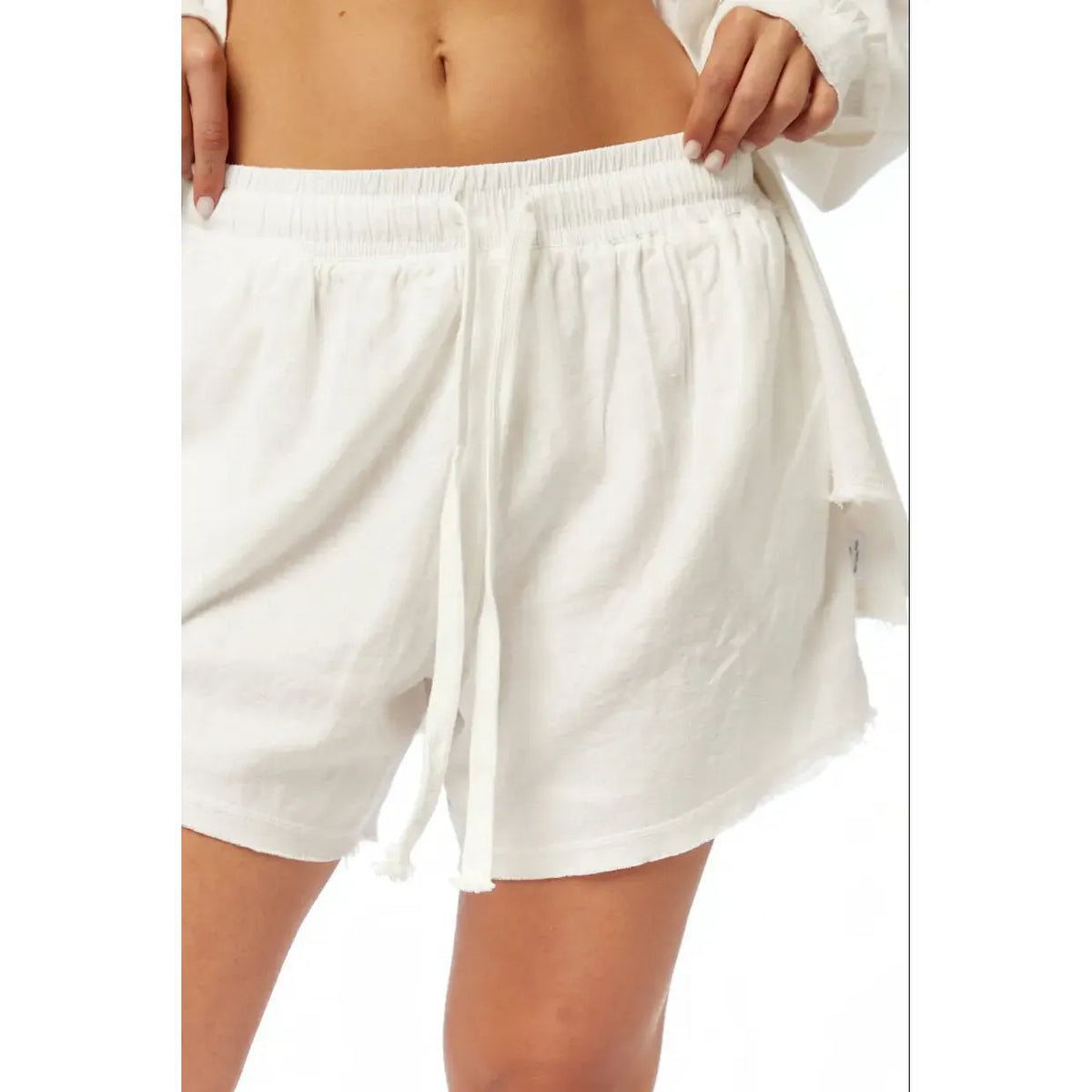 Pure Linen Women's Shorts in white, with a drawstring waist and frayed hem, worn by a person