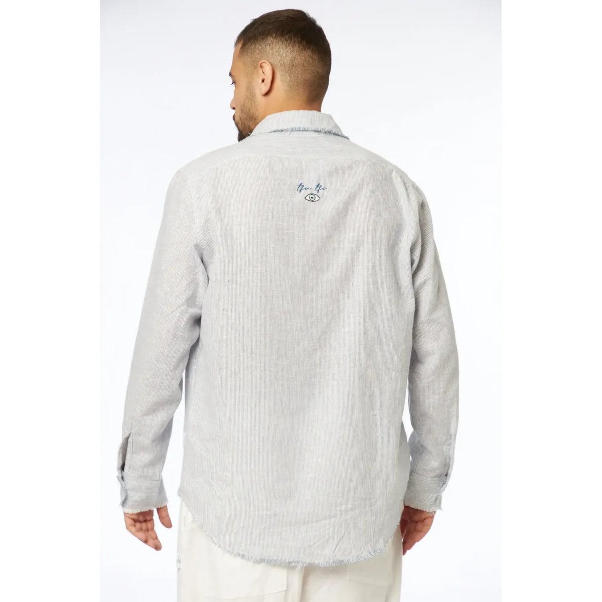 Man wearing a gray fleece jacket with branding on the back against a white background