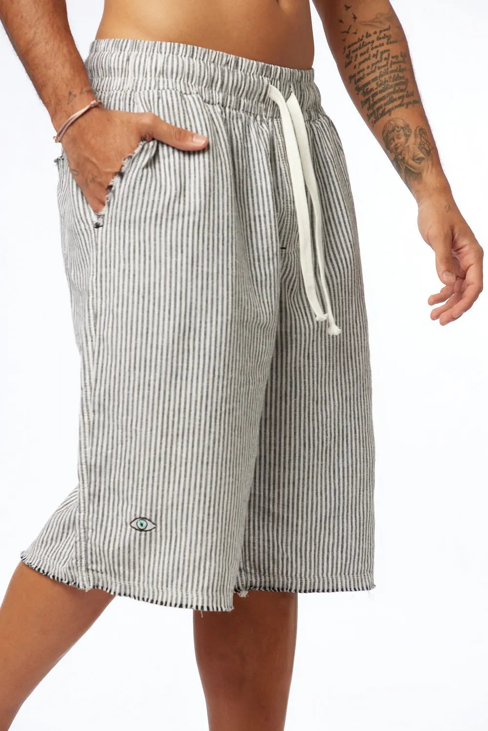 Striped Bermuda Shorts - Black with white drawstring, eye logo on left leg, and frayed hem