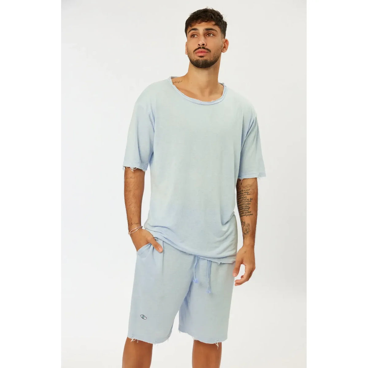Man wearing Nicki Soft Open Top in Light Blue with matching shorts