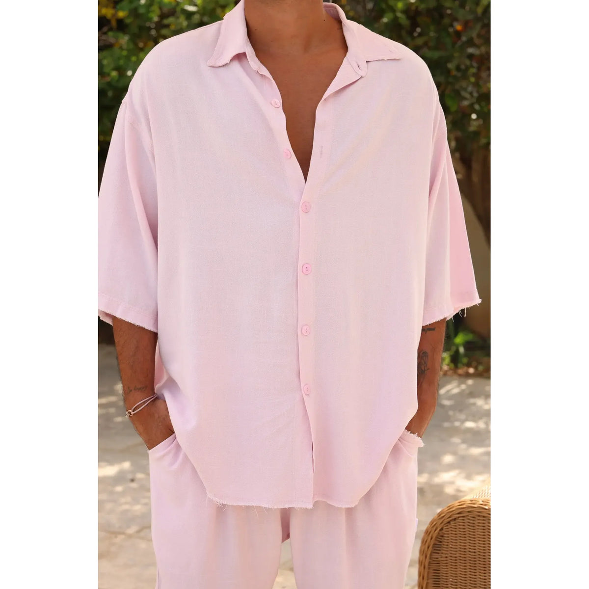 Soft Linen Short Sleeve Button-Up Shirt in Baby Pink, worn by a person with hands in pockets
