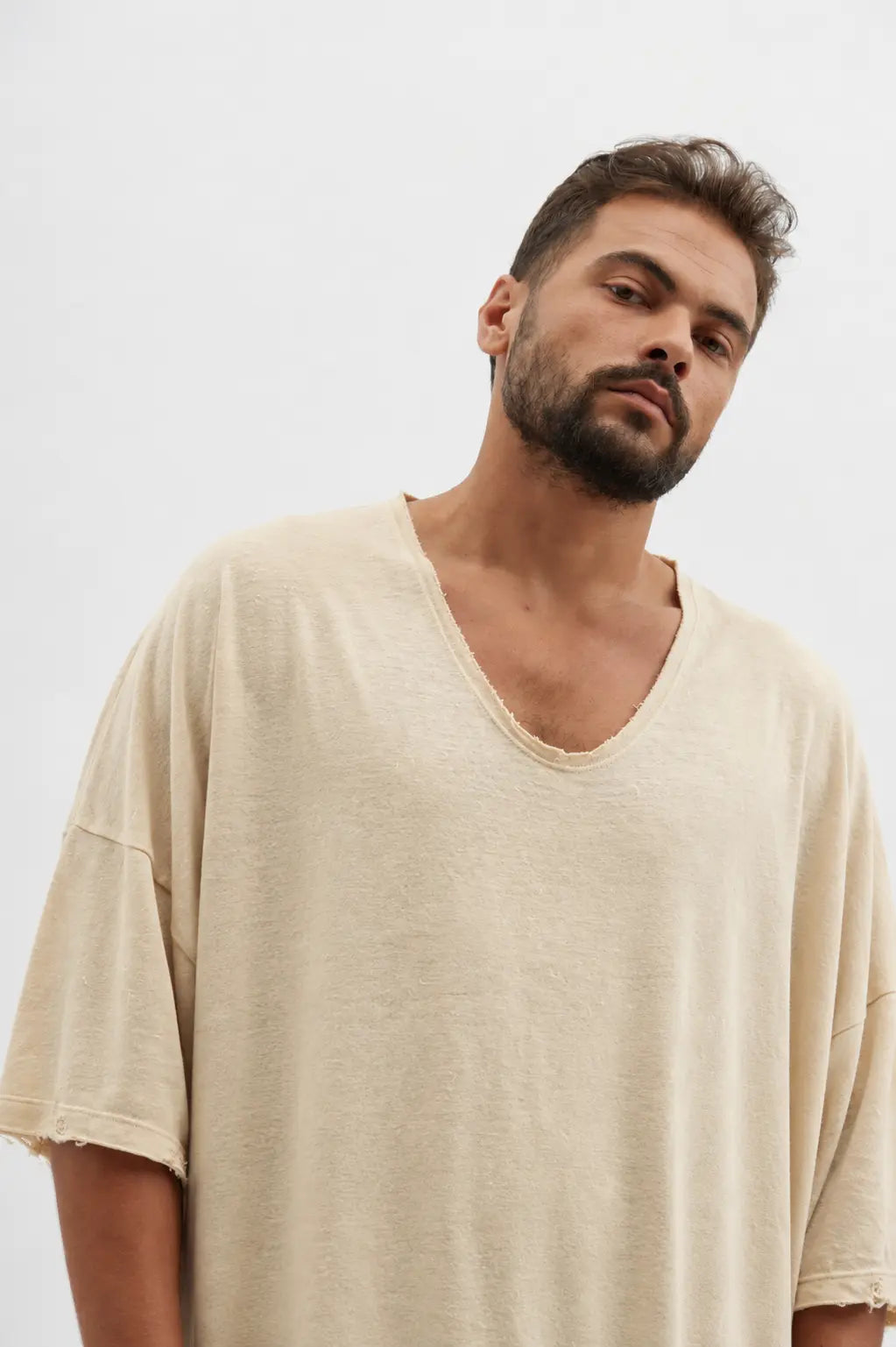 Man wearing a stone Dor Oversized Shirt with a v-neck