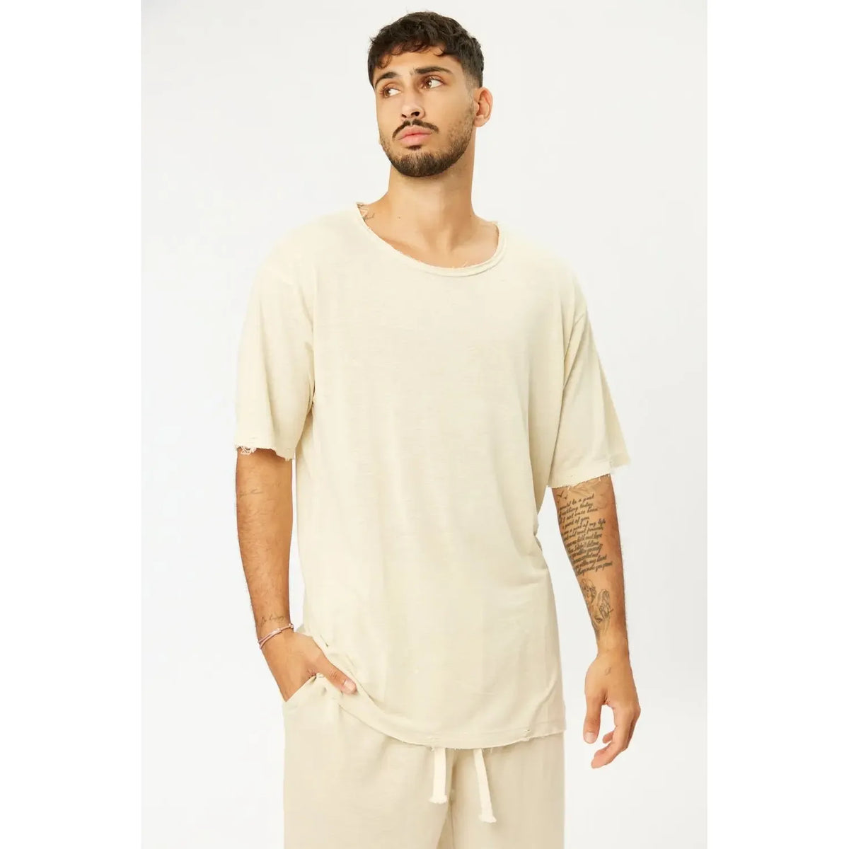 TFU Soft Essential Tee in light stone worn by a man with a beard and tattoos, paired with matching light stone shorts