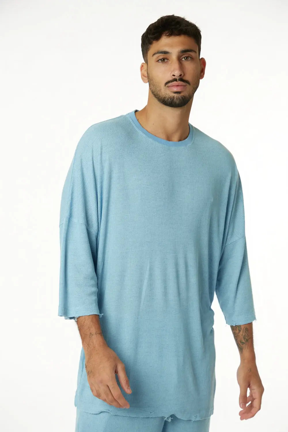 3/4 Sleeve Nicki Rib in blue, worn by a man with a beard, standing against a white background