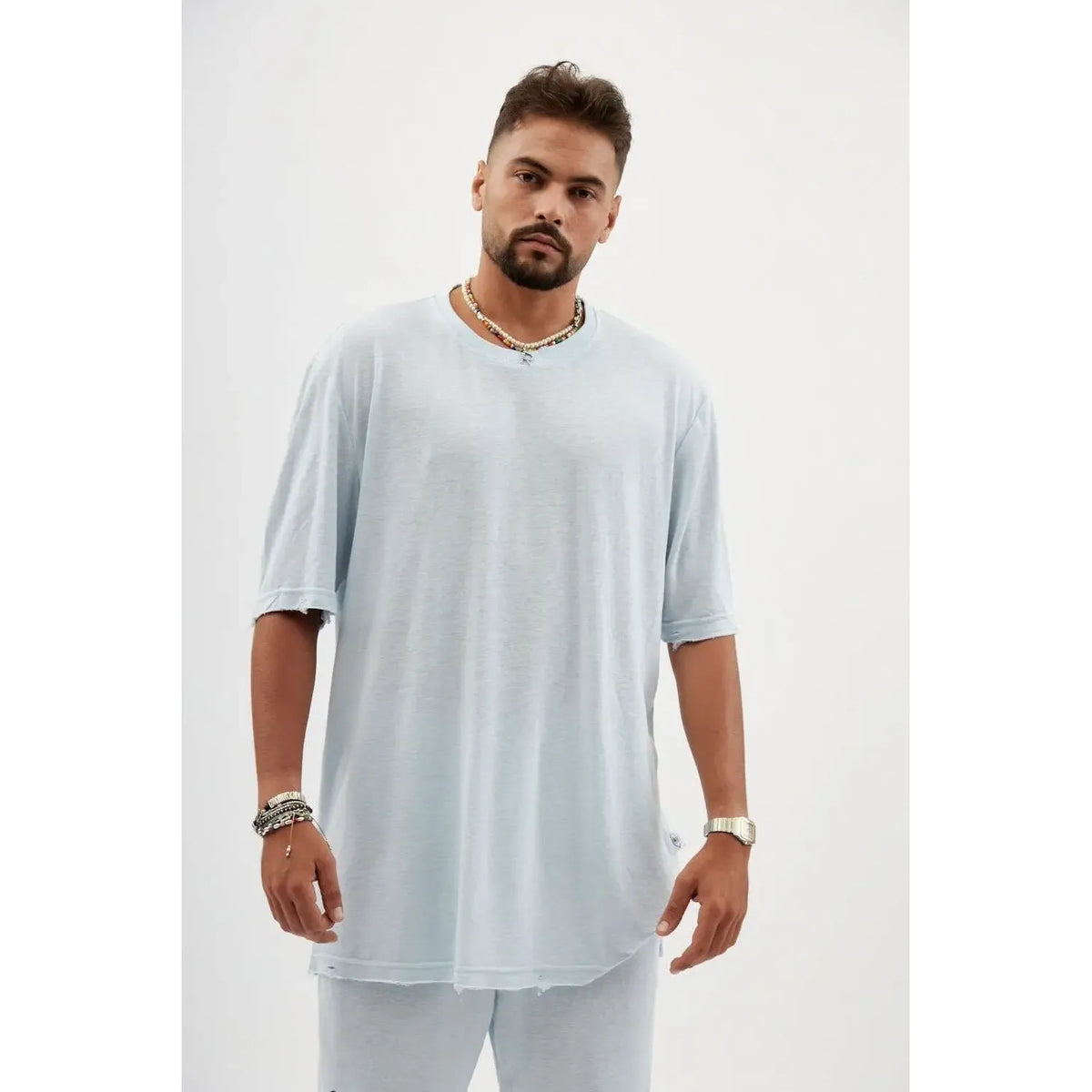 TFU Soft Essential Tee in sky blue worn by a man with a beard, necklaces, and bracelets