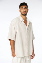 Man wearing a Striped Linen Short Sleeve Button-Up Shirt in Stone