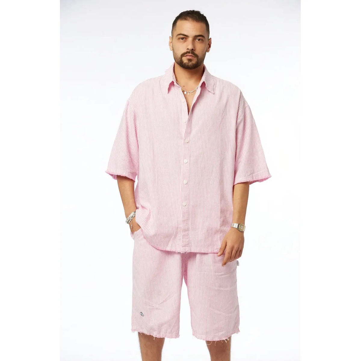 Man wearing a pink striped short-sleeved shirt and matching Striped Bermuda Shorts - Pink