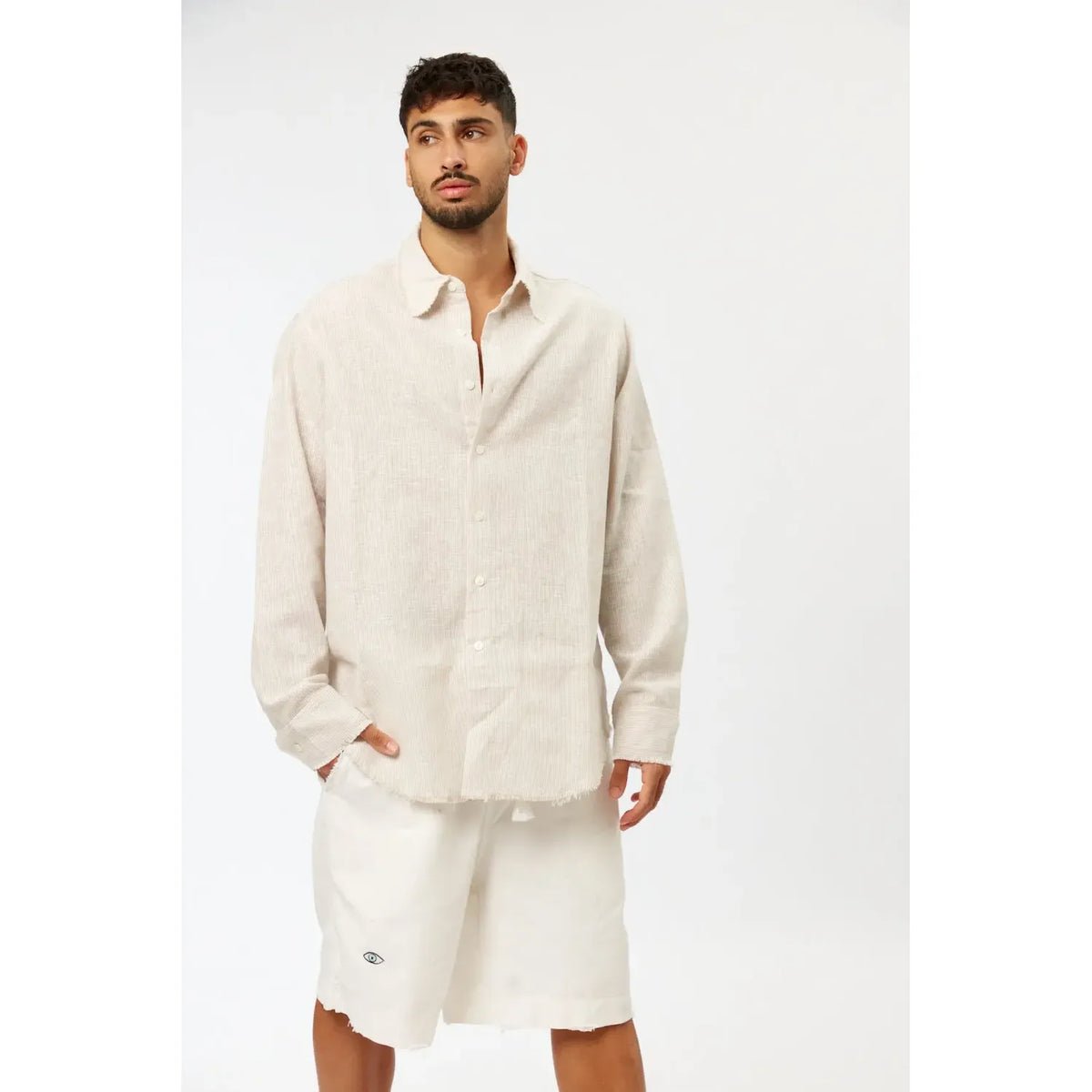 Man wearing a Striped PURE Long Sleeve Linen Button-Up Shirt in Stone with white shorts
