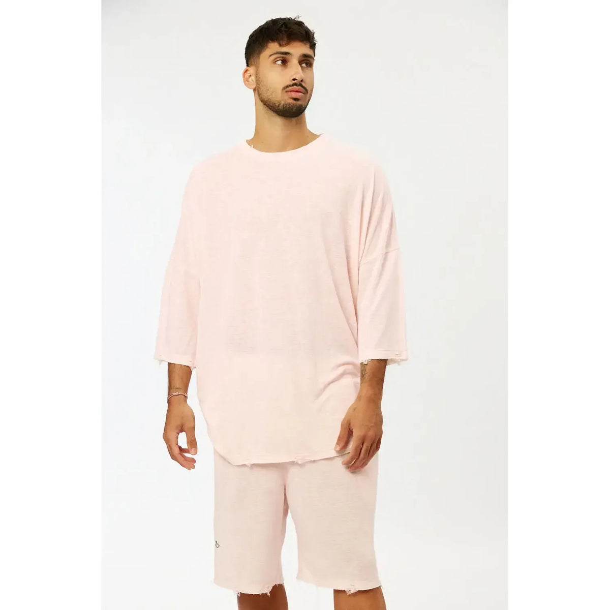 Man wearing Base Shorts in baby pink with matching oversized t-shirt