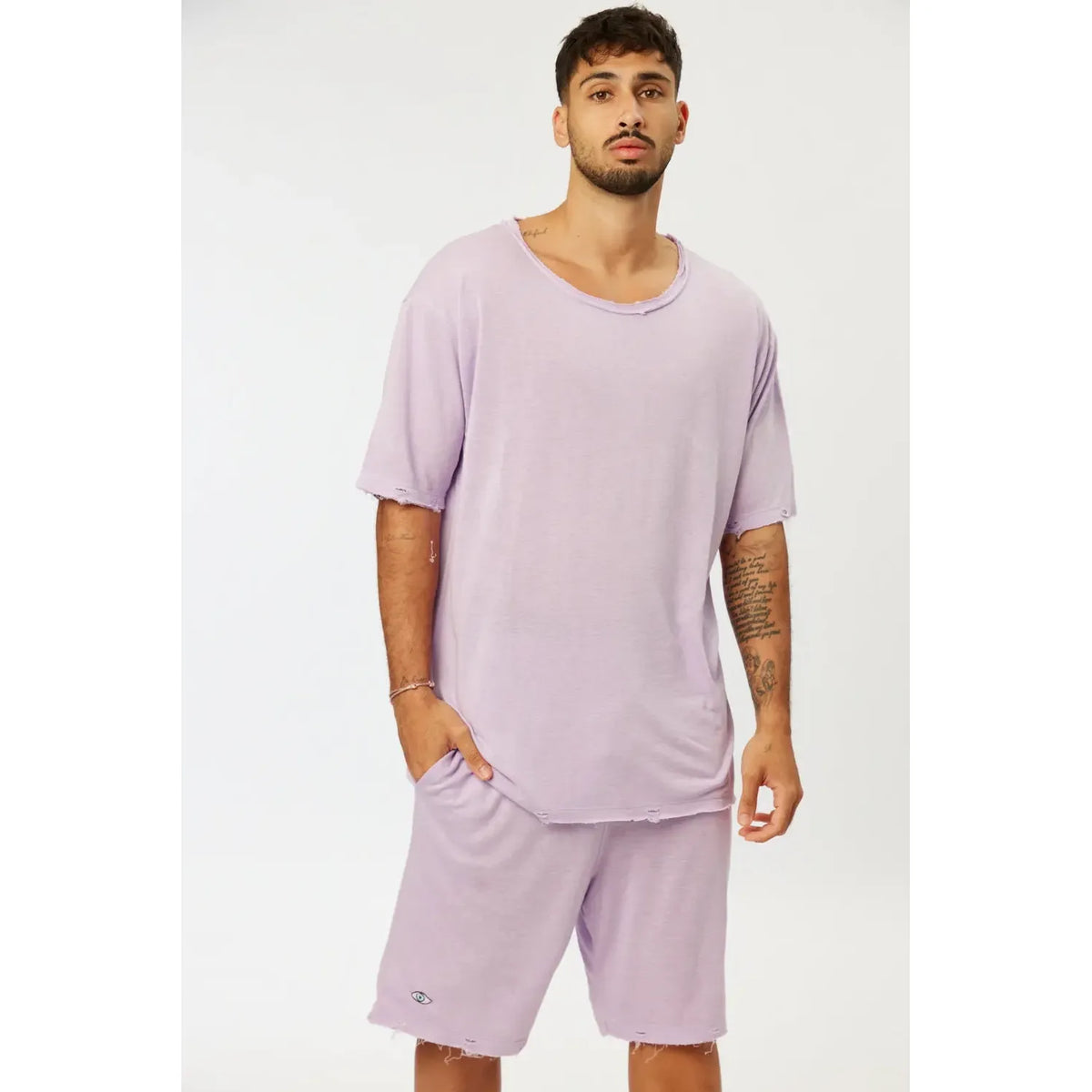Man wearing Nicki Soft Open Top in purple with matching shorts