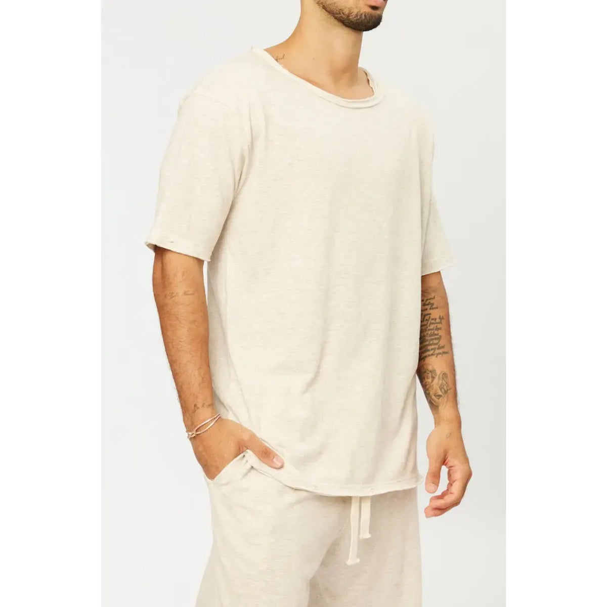 Nicki Soft Open Top in melange stone, worn by a person with a hand in their pocket