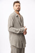 Man wearing a beige corduroy outfit on a white background