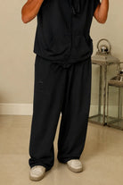 French terry Oversized Sweatpants in black with distressed details and an eye graphic on the left leg