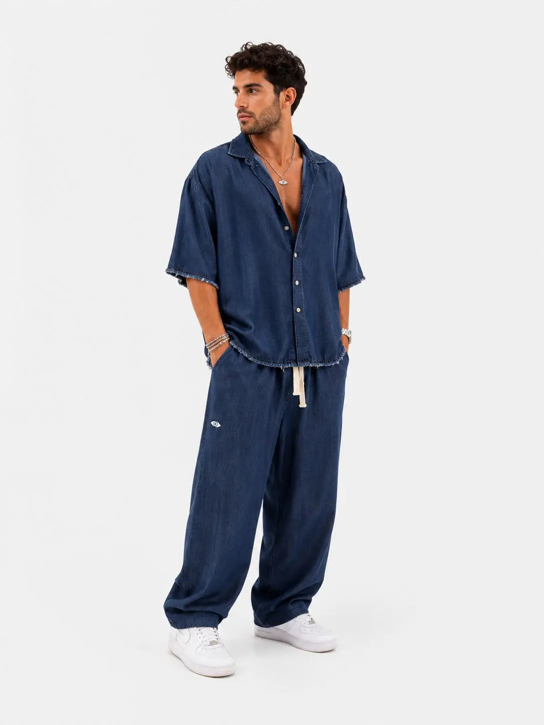 Man wearing TFU Oversized Denim Pants and matching short-sleeved shirt