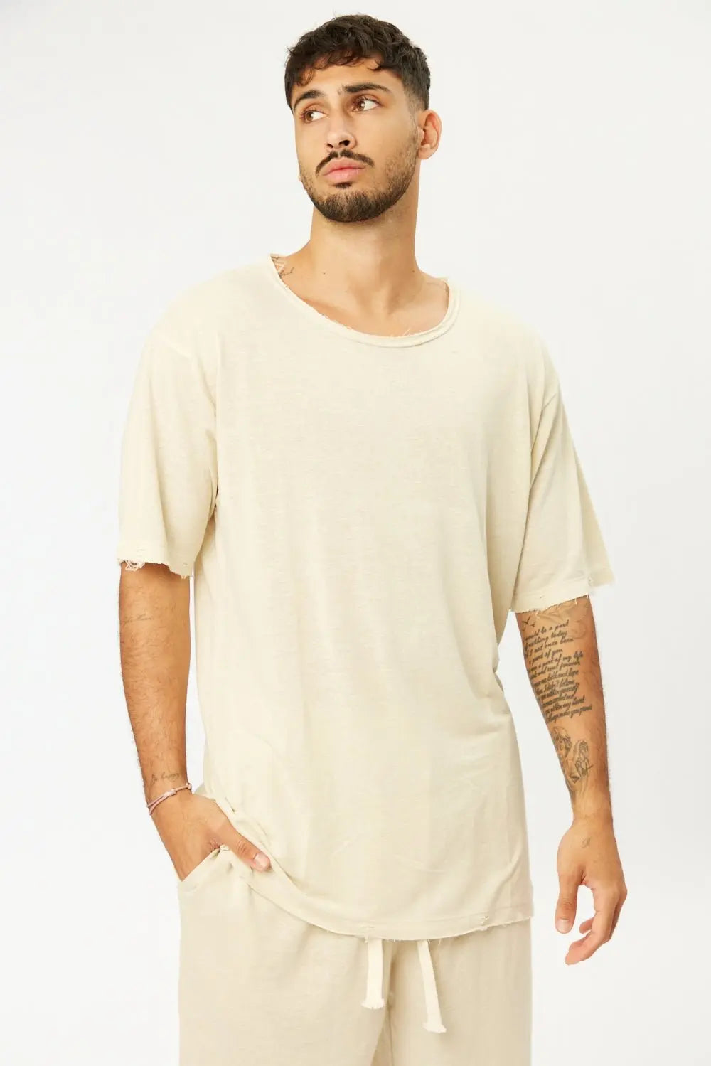 TFU Soft Essential Tee in light stone worn by a man with a beard and tattoos, paired with matching light stone shorts