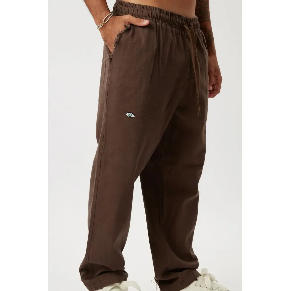 DC SL Pants in brown with an eye logo on the left thigh
