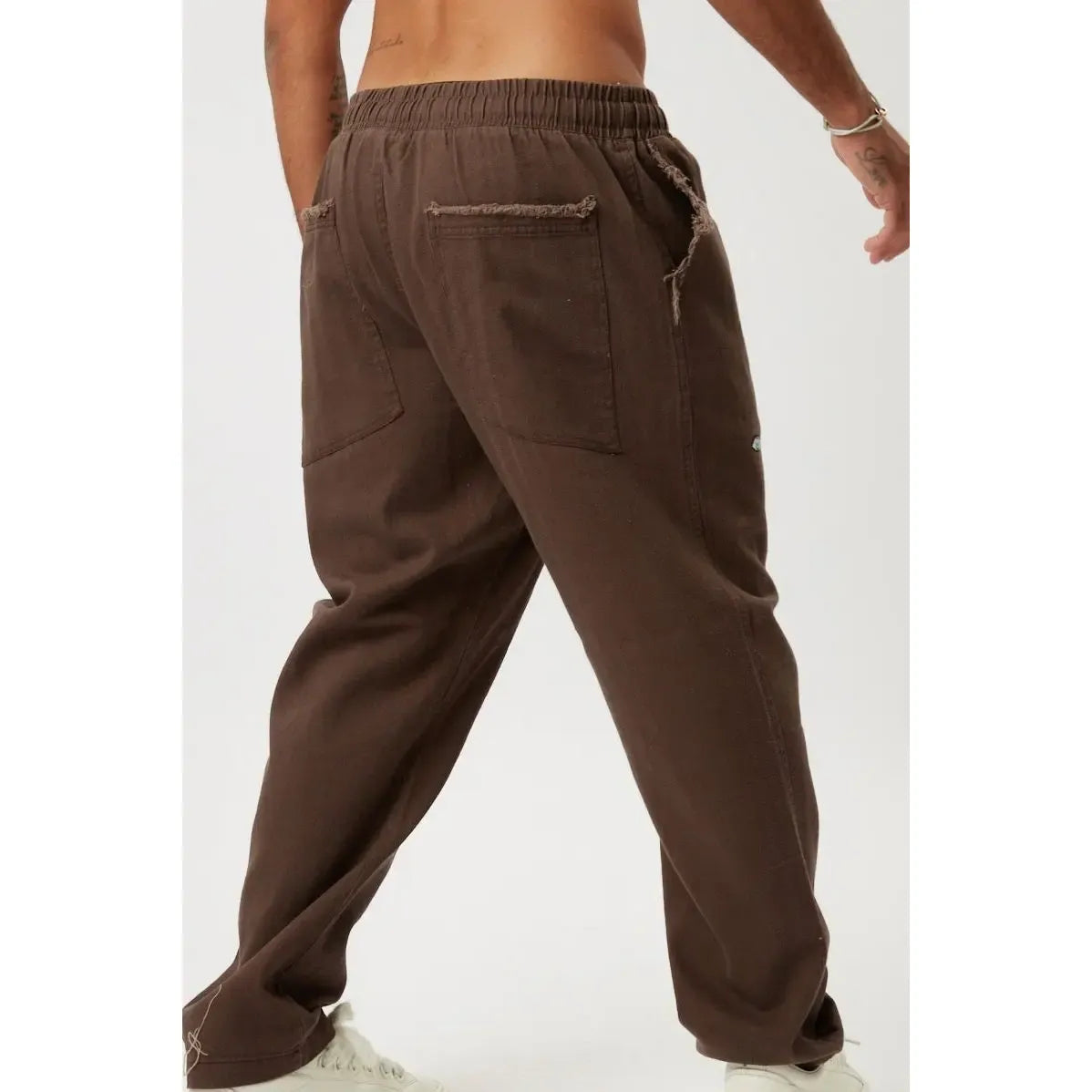 DC SL Pants in brown with elastic waistband and distressed pockets