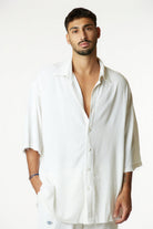 Man wearing a cream Soft Linen Short Sleeve Button-Up Shirt