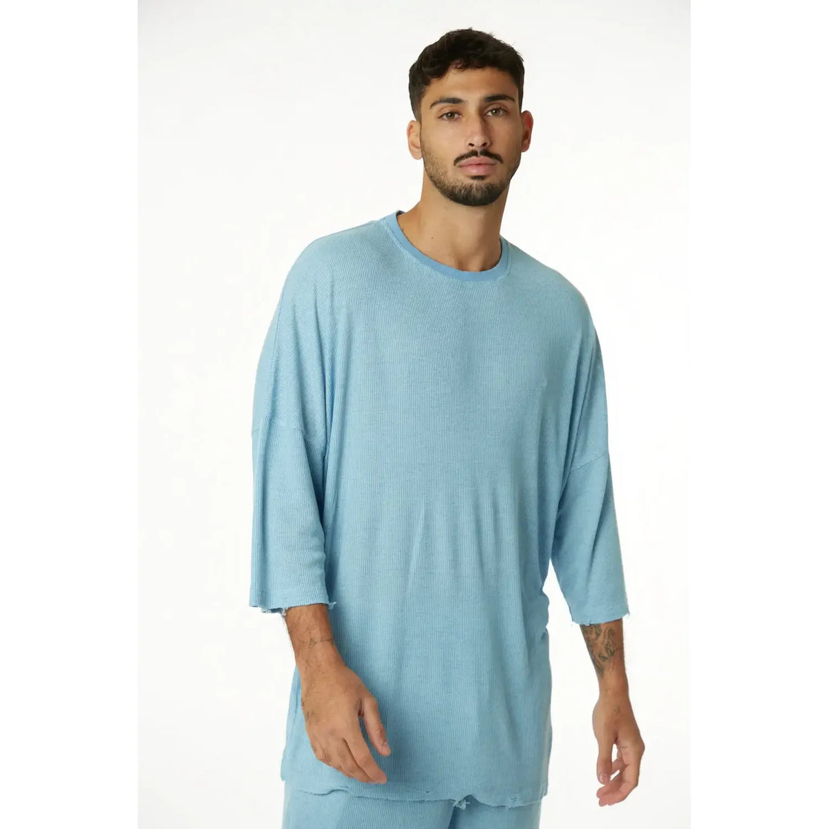 3/4 Sleeve Nicki Rib in blue, worn by a man with a beard, standing against a white background