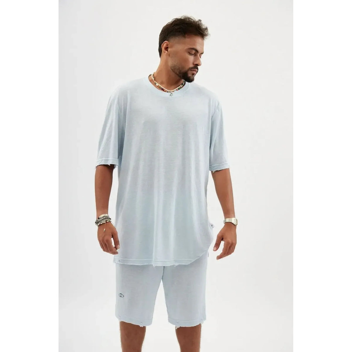 Man wearing a TFU Soft Essential Tee in sky blue with matching shorts and accessories