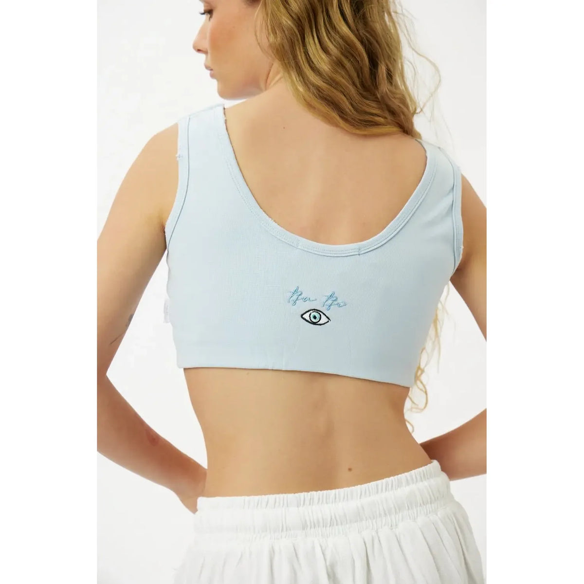 Essential Crop Top in light blue with an eye graphic on the back