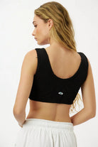 Essential Crop Top - Black, back view, with an eye graphic on the lower back