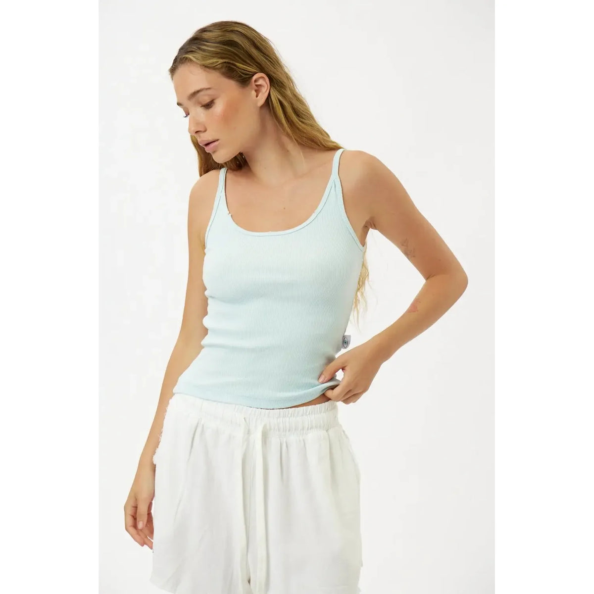 Slim Cotton Tank Top in Sky Blue worn by a woman with long blonde hair and white shorts