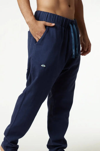 DC Fisherman Pants in blue, with a drawstring waist and an eye logo on the left leg