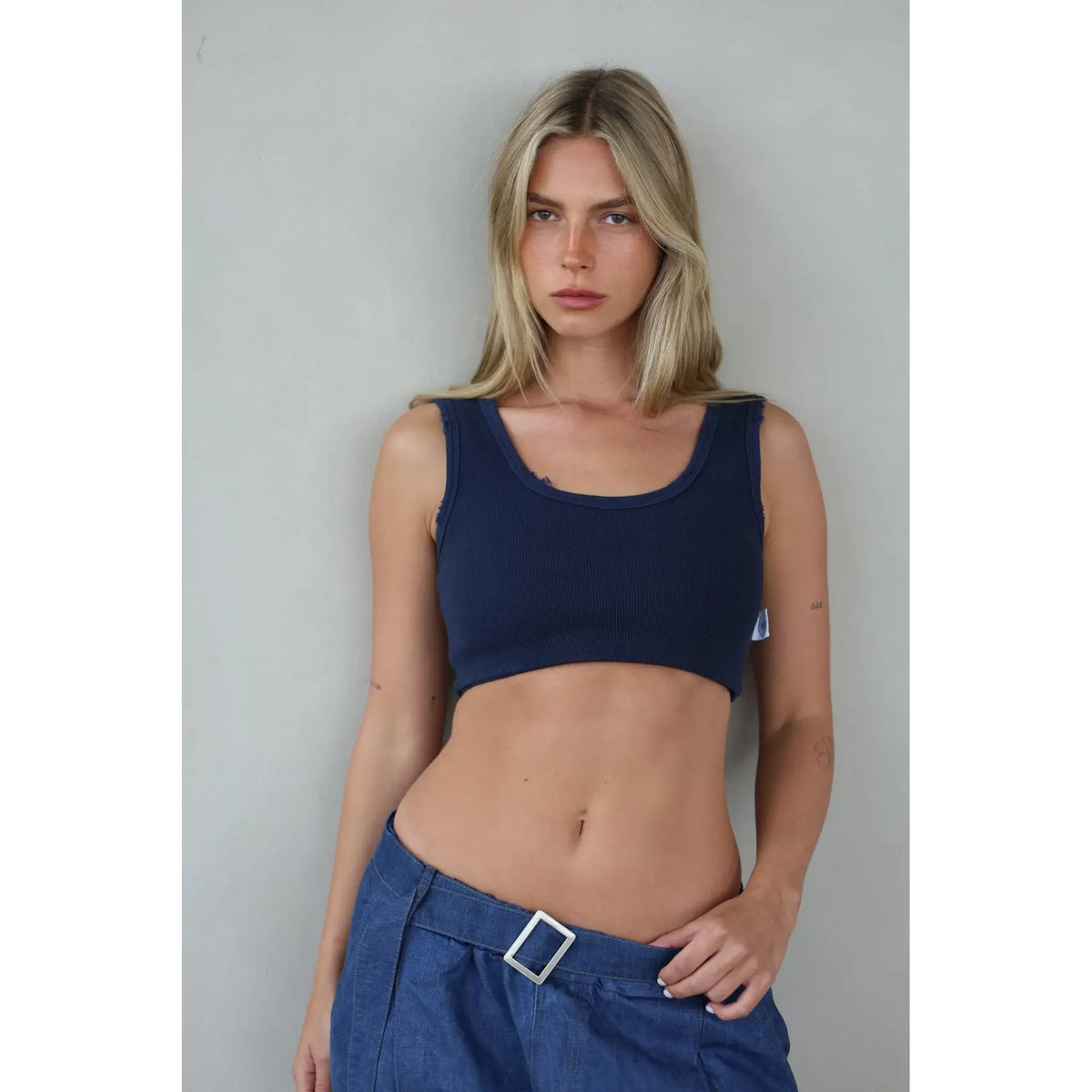 Essential Crop Top in navy blue on a model with blonde hair and blue jeans