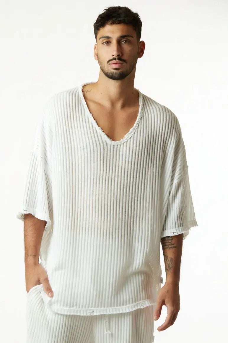 Man wearing a cream white striped knit shirt with a v-neck and short sleeves